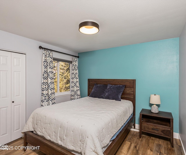 25656 Bendilent Cir, Eagle River, AK 99577 - bedroom with a closet, baseboards, and wood finished floors