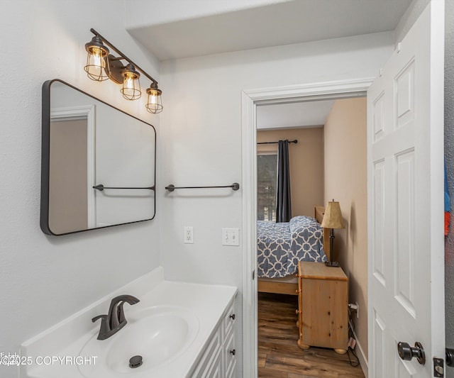 25656 Bendilent Cir, Eagle River, AK 99577 - ensuite bathroom featuring wood finished floors, vanity, and ensuite bath