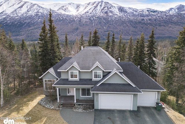 25656 Bendilent Cir, Eagle River, AK 99577 - view of front facade featuring a mountain view, a wooded view, covered porch, and aphalt driveway