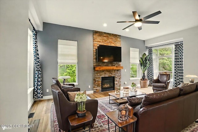 25656 Bendilent Cir, Eagle River, AK 99577 - living area featuring ceiling fan, wood finished floors, a stone fireplace, recessed lighting, and baseboards