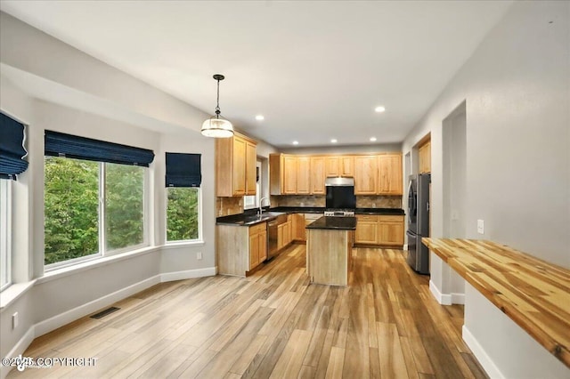25656 Bendilent Cir, Eagle River, AK 99577 - kitchen featuring appliances with stainless steel finishes, light wood-style floors, backsplash, baseboards, and recessed lighting