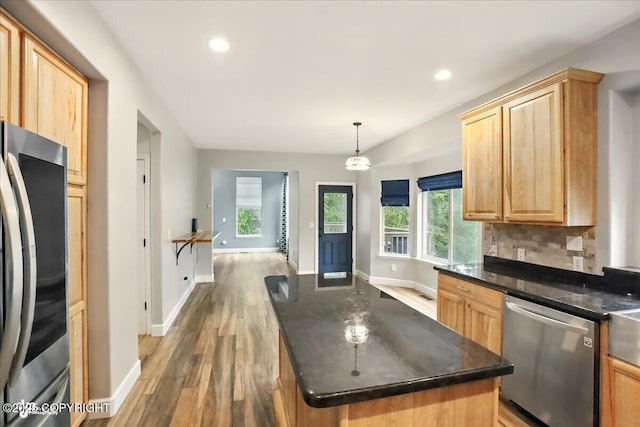 25656 Bendilent Cir, Eagle River, AK 99577 - kitchen featuring appliances with stainless steel finishes, dark countertops, light brown cabinetry, light wood-style flooring, and baseboards