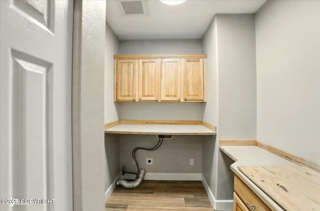 25656 Bendilent Cir, Eagle River, AK 99577 - washroom with wood finished floors, electric dryer hookup, baseboards, and cabinet space