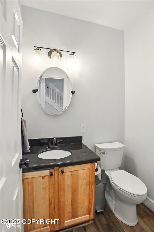 25656 Bendilent Cir, Eagle River, AK 99577 - half bath with vanity, wood finished floors, and toilet
