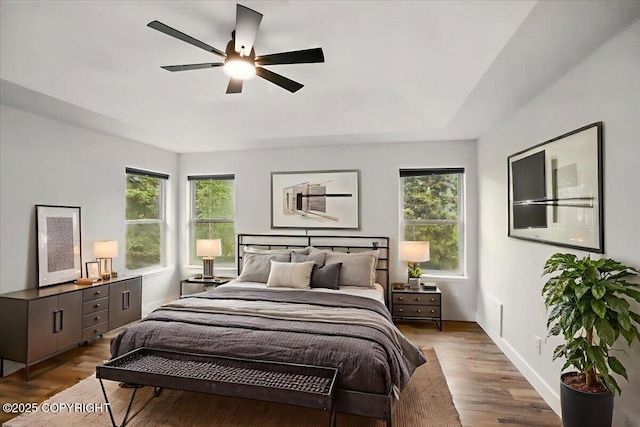 25656 Bendilent Cir, Eagle River, AK 99577 - bedroom with multiple windows, wood finished floors, baseboards, and ceiling fan