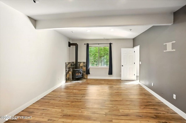 25656 Bendilent Cir, Eagle River, AK 99577 - unfurnished living room with a wood stove, light wood-style floors, and baseboards