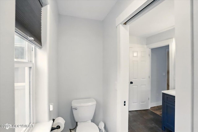 25656 Bendilent Cir, Eagle River, AK 99577 - bathroom with toilet, vanity, and wood finished floors