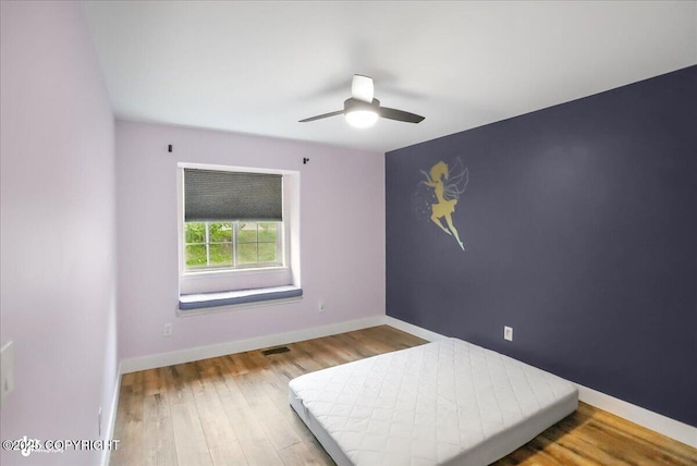 25656 Bendilent Cir, Eagle River, AK 99577 - bedroom featuring wood finished floors, baseboards, and a ceiling fan