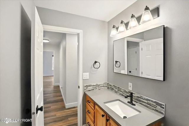 25656 Bendilent Cir, Eagle River, AK 99577 - bathroom featuring wood finished floors, vanity, and baseboards