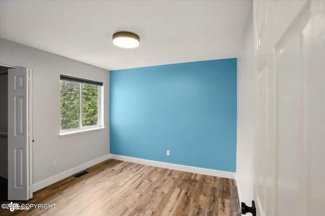 25656 Bendilent Cir, Eagle River, AK 99577 - unfurnished bedroom featuring wood finished floors and baseboards