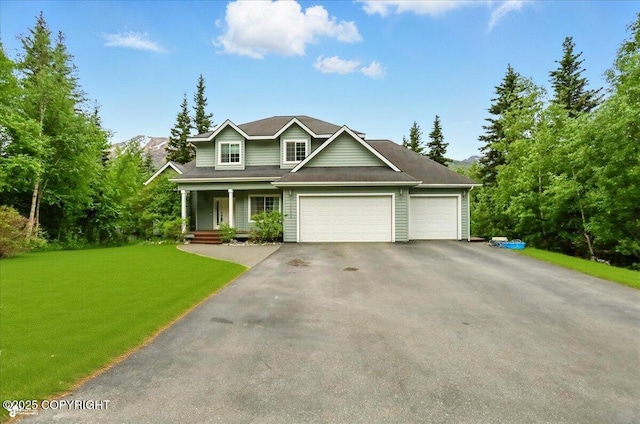 25656 Bendilent Cir, Eagle River, AK 99577 - view of front of property with covered porch, an attached garage, asphalt driveway, and a front yard