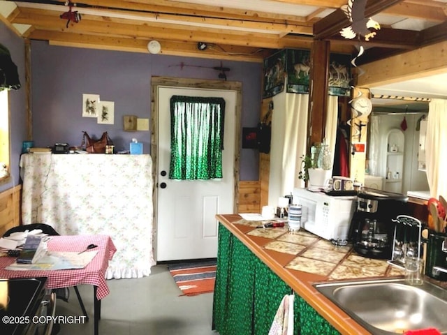 12656 D Meadow Dr, Ninilchik, AK 99639 - kitchen featuring finished concrete flooring, white microwave, tile countertops, and a sink