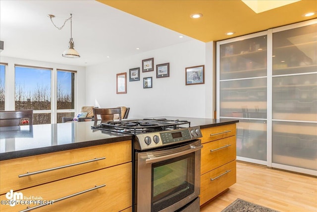 1382 Northbluff Dr # 4B, Anchorage, AK 99501 - kitchen with recessed lighting, light wood-type flooring, stainless steel gas range, and brown cabinets