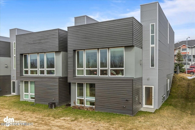 1382 Northbluff Dr # 4B, Anchorage, AK 99501 - rear view of house featuring a chimney and a lawn