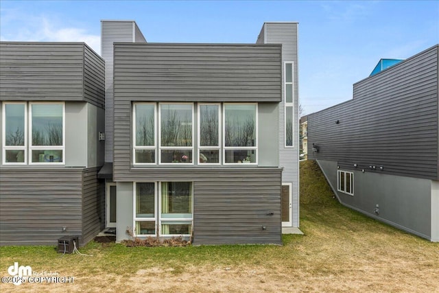1382 Northbluff Dr # 4B, Anchorage, AK 99501 - back of house featuring a lawn and a chimney