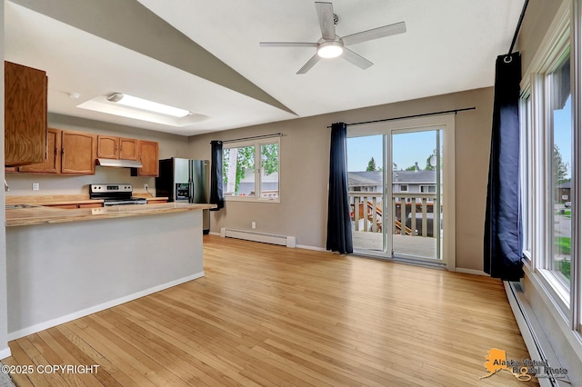 8400 E 11th Ct, Anchorage, AK 99504 - kitchen with range with electric stovetop, a baseboard radiator, under cabinet range hood, light wood-type flooring, and vaulted ceiling