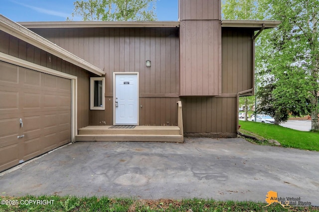 8400 E 11th Ct, Anchorage, AK 99504 - doorway to property featuring a garage and a chimney