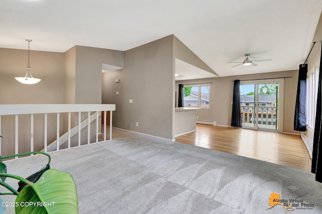 8400 E 11th Ct, Anchorage, AK 99504 - empty room with a baseboard heating unit, light carpet, a ceiling fan, lofted ceiling, and baseboards