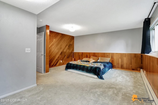 8400 E 11th Ct, Anchorage, AK 99504 - bedroom with baseboard heating, wooden walls, carpet, baseboards, and a textured ceiling