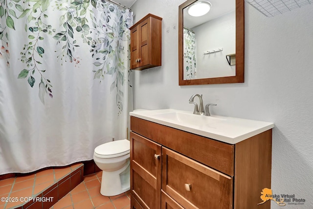 8400 E 11th Ct, Anchorage, AK 99504 - bathroom with vanity, toilet, tile patterned floors, and a shower with shower curtain