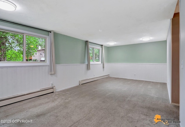 8400 E 11th Ct, Anchorage, AK 99504 - empty room featuring baseboard heating, wainscoting, and carpet flooring