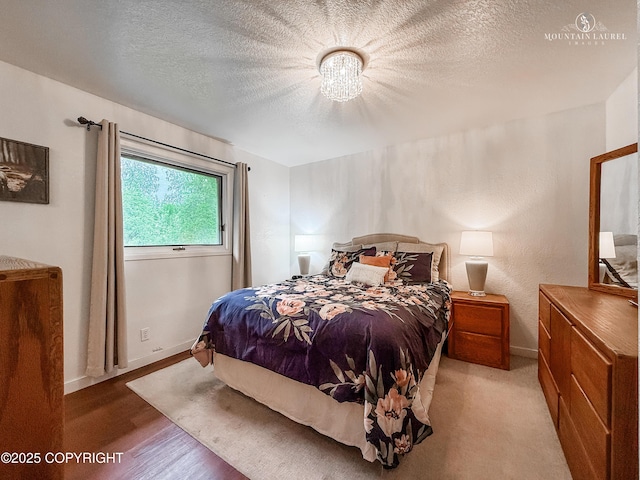 6934 Inlet Vista Dr, Wasilla, AK 99623 - bedroom with a textured ceiling and light wood finished floors