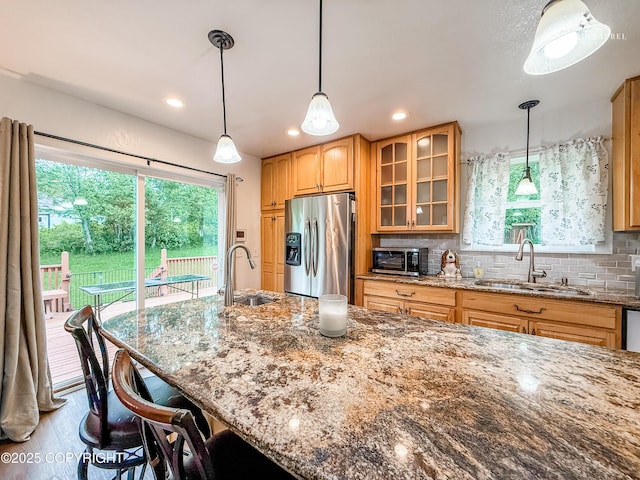 6934 Inlet Vista Dr, Wasilla, AK 99623 - kitchen with stainless steel appliances, dark stone countertops, a kitchen bar, glass insert cabinets, and backsplash