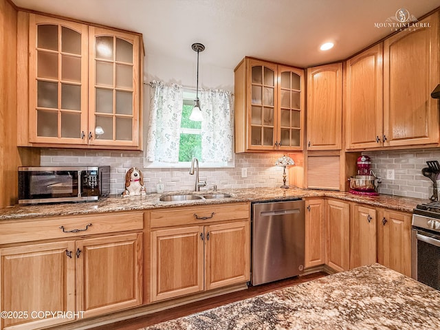 6934 Inlet Vista Dr, Wasilla, AK 99623 - kitchen with stainless steel appliances, light stone counters, decorative backsplash, wood finished floors, and glass insert cabinets