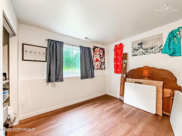 6934 Inlet Vista Dr, Wasilla, AK 99623 - unfurnished bedroom featuring wood finished floors and baseboards