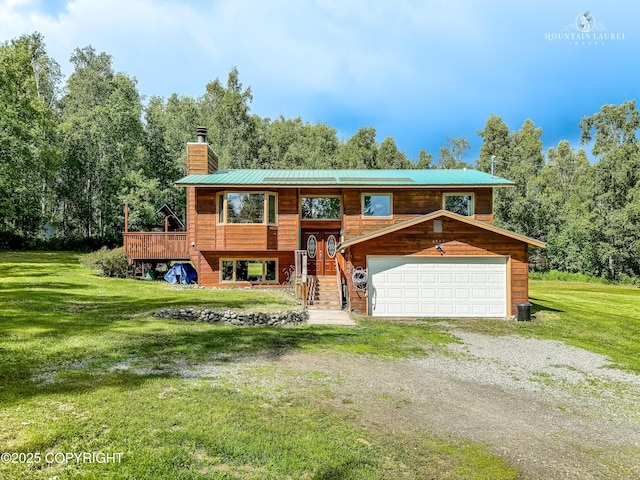 6934 Inlet Vista Dr, Wasilla, AK 99623 - split foyer home featuring a chimney, a front lawn, driveway, and a garage