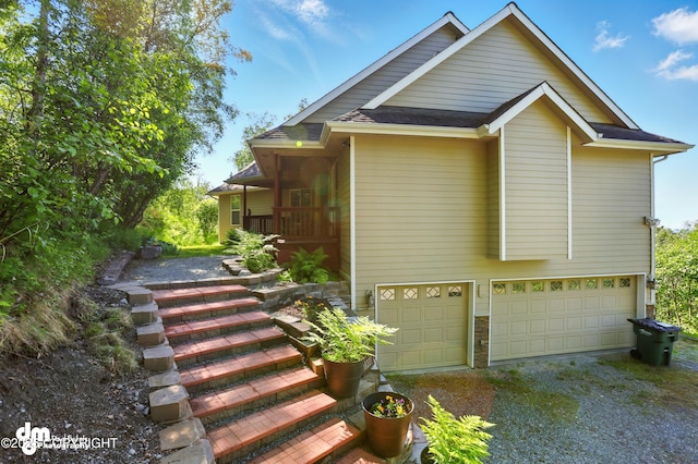 18221 Amonson Rd, Chugiak, AK 99567 - view of side of property with gravel driveway and an attached garage