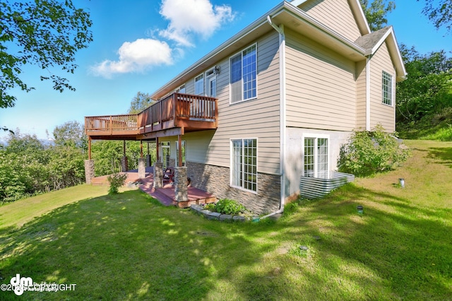 18221 Amonson Rd, Chugiak, AK 99567 - rear view of property with a patio area, a lawn, a wooden deck, and stone siding