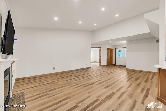 11510 Tulin Park Loop, Anchorage, AK 99516 - unfurnished living room featuring light wood-style floors, recessed lighting, a fireplace, and baseboards