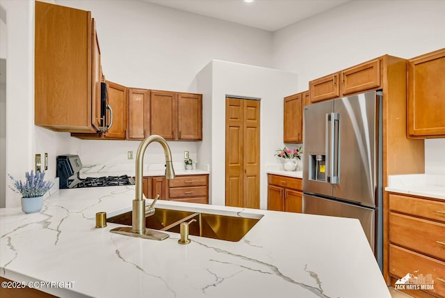 11510 Tulin Park Loop, Anchorage, AK 99516 - kitchen with high end refrigerator, stove, a sink, and brown cabinetry