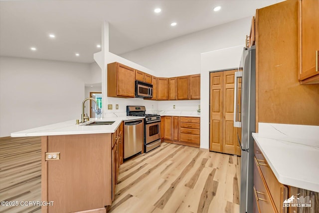 11510 Tulin Park Loop, Anchorage, AK 99516 - kitchen featuring stainless steel appliances, a sink, light wood-style flooring, recessed lighting, and a peninsula