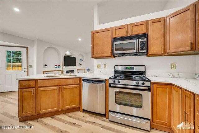 11510 Tulin Park Loop, Anchorage, AK 99516 - kitchen with appliances with stainless steel finishes, a peninsula, light wood-style flooring, recessed lighting, and open floor plan
