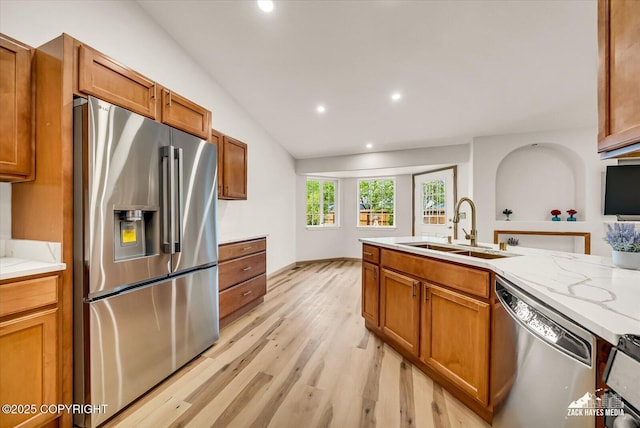 11510 Tulin Park Loop, Anchorage, AK 99516 - kitchen featuring stainless steel appliances, a sink, light wood-style floors, brown cabinets, and recessed lighting