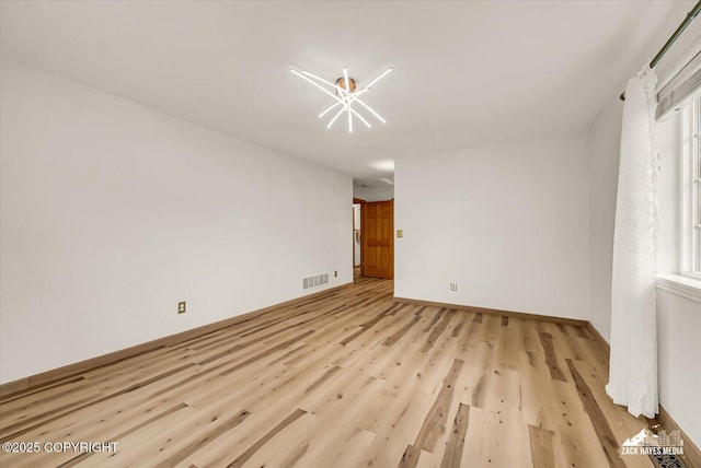 11510 Tulin Park Loop, Anchorage, AK 99516 - unfurnished room with light wood-style floors and baseboards