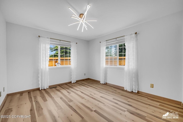 11510 Tulin Park Loop, Anchorage, AK 99516 - empty room with healthy amount of natural light, light wood finished floors, and baseboards