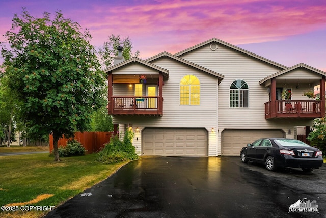 2578 Glacier St # 8, Anchorage, AK 99508 - view of front of home featuring a garage, a balcony, asphalt driveway, and a chimney