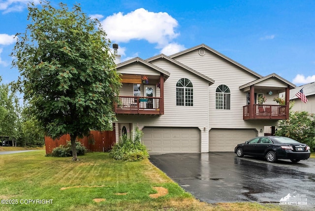 2578 Glacier St # 8, Anchorage, AK 99508 - view of front of property featuring a balcony, a garage, asphalt driveway, and a front lawn