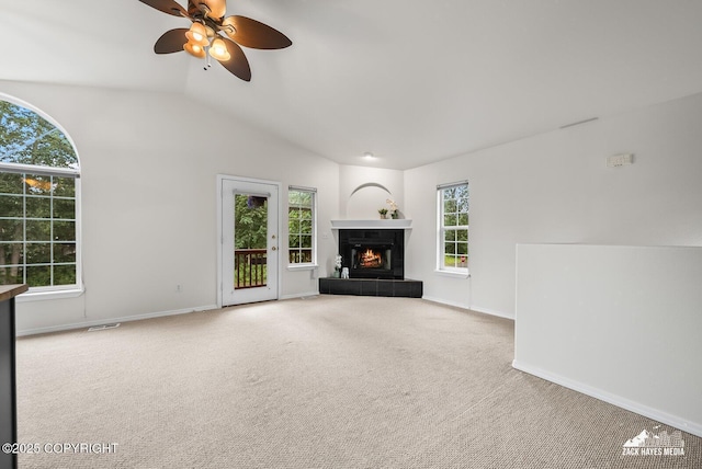 2578 Glacier St # 8, Anchorage, AK 99508 - unfurnished living room with carpet flooring, lofted ceiling, a ceiling fan, and a tile fireplace