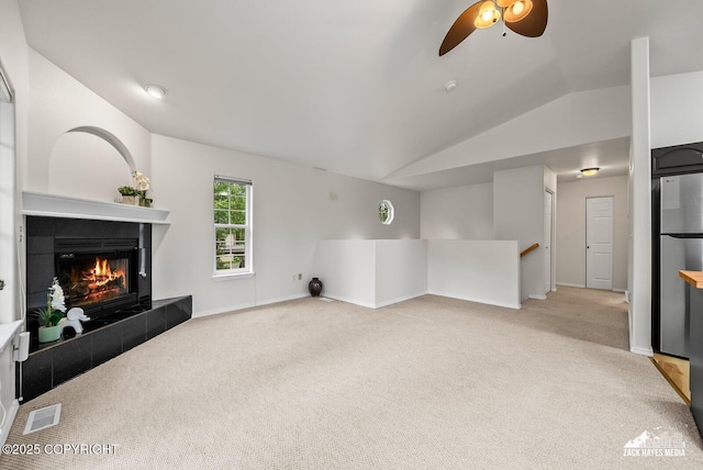 2578 Glacier St # 8, Anchorage, AK 99508 - unfurnished living room with lofted ceiling, ceiling fan, light colored carpet, and a fireplace