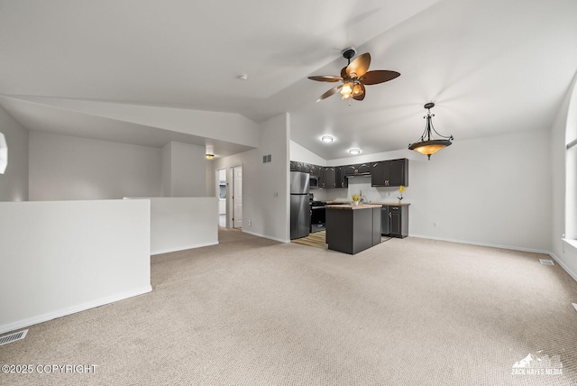 2578 Glacier St # 8, Anchorage, AK 99508 - unfurnished living room featuring a ceiling fan, light carpet, and vaulted ceiling