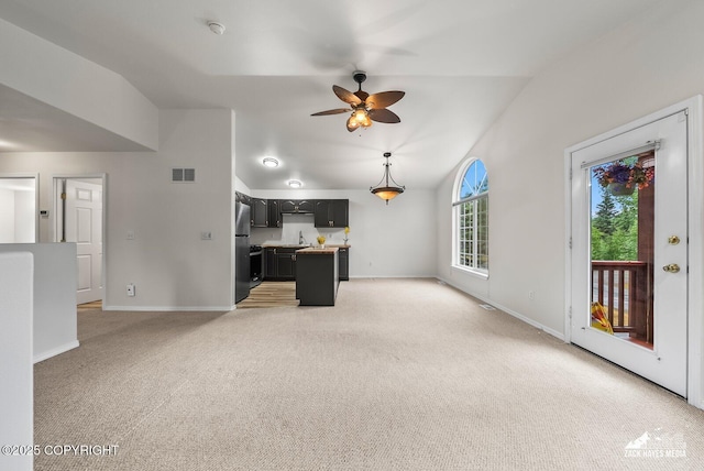 2578 Glacier St # 8, Anchorage, AK 99508 - unfurnished living room with lofted ceiling, light carpet, and ceiling fan