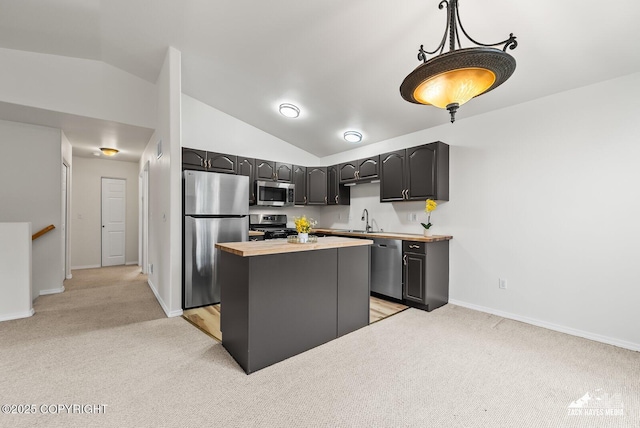 2578 Glacier St # 8, Anchorage, AK 99508 - kitchen with stainless steel appliances, light colored carpet, lofted ceiling, a kitchen island, and butcher block counters