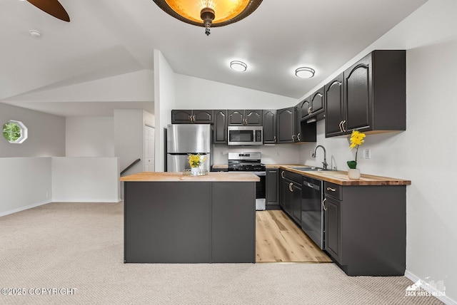 2578 Glacier St # 8, Anchorage, AK 99508 - kitchen featuring stainless steel appliances, butcher block counters, lofted ceiling, a center island, and light carpet