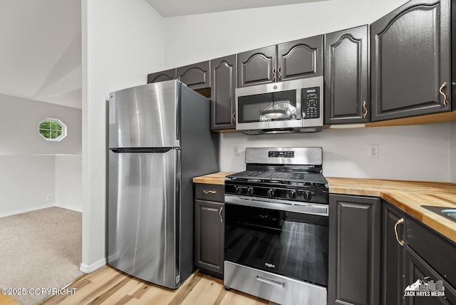 2578 Glacier St # 8, Anchorage, AK 99508 - kitchen featuring stainless steel appliances, wood counters, and light wood-style flooring
