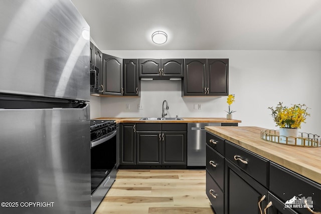 2578 Glacier St # 8, Anchorage, AK 99508 - kitchen with stainless steel appliances, butcher block counters, and light wood finished floors