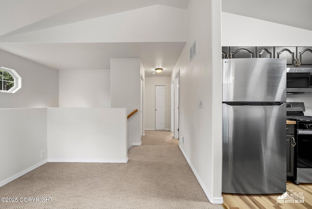 2578 Glacier St # 8, Anchorage, AK 99508 - corridor with an upstairs landing, light colored carpet, and lofted ceiling